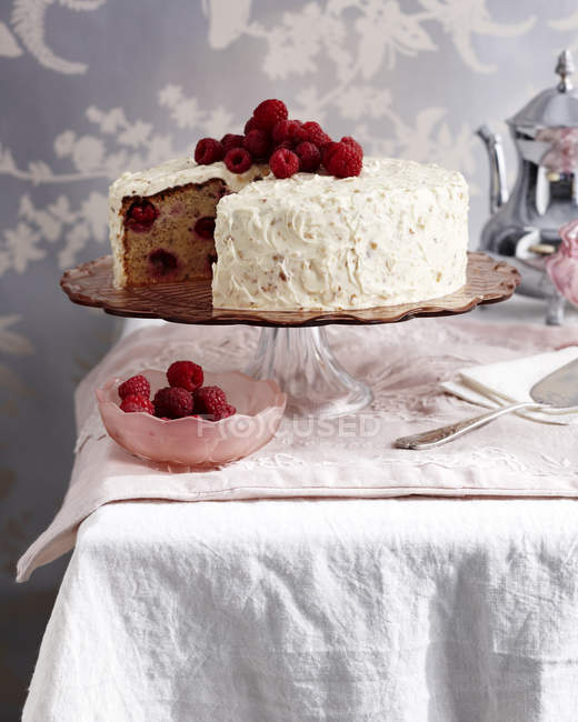 Raspberry hazelnut cake on traditional tea table — Stock Photo
