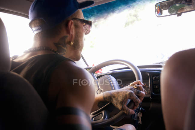 Close-up of young man driving on car road trip — Stock Photo