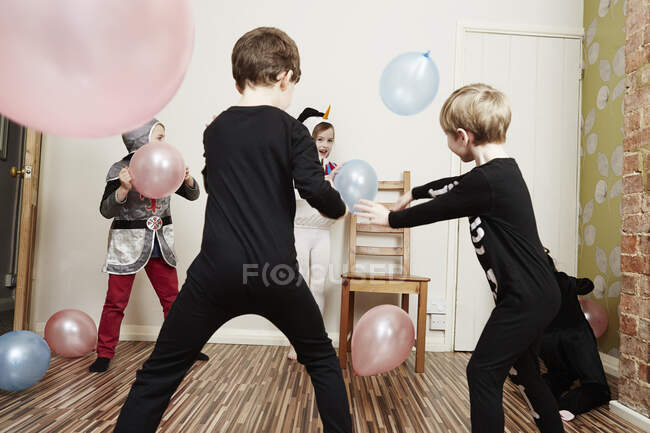 Children playing with balloons at birthday party — Stock Photo