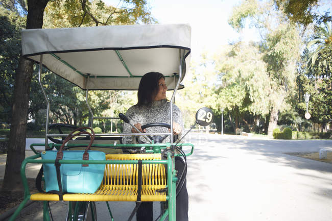 Mature woman sitting in golf buggy, looking away, Seville, Spain — Stock Photo