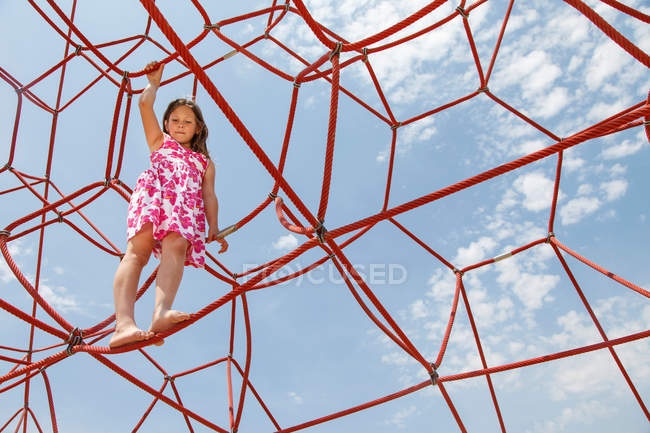 Girl playing on ropes outdoors — Stock Photo