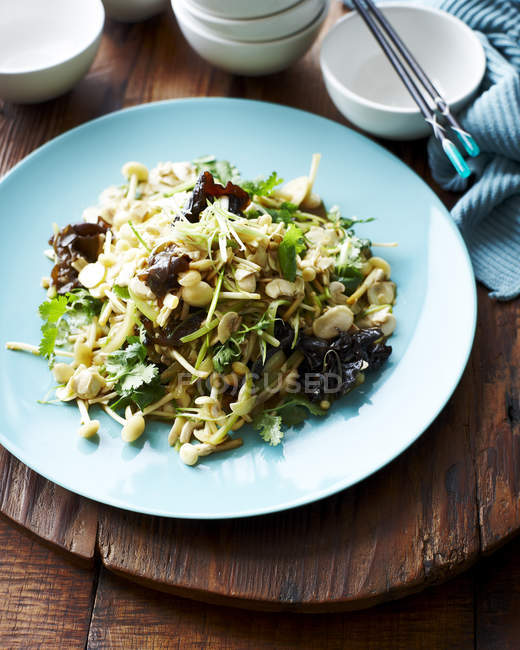 Mushroom and celery salad served on blue plate — Stock Photo
