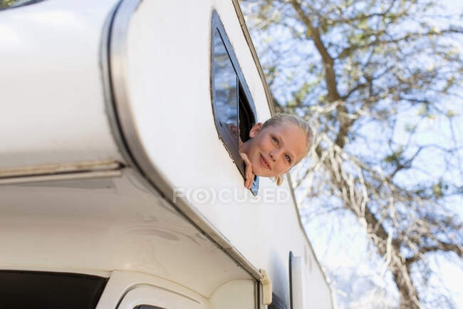 Girl peering out of RV — Stock Photo