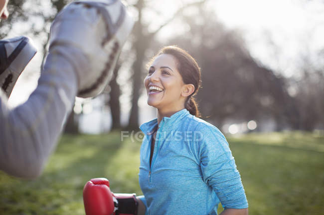 Young woman doing boxing training in park — Stock Photo