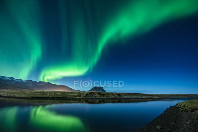 Céu com aurora boreal refletindo na água do mar — Fotografia de Stock
