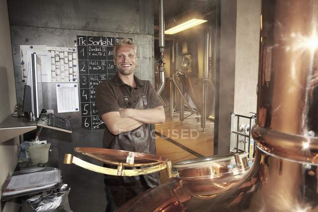 Портрет молодого пивовара, улыбающегося в камеру — стоковое фото