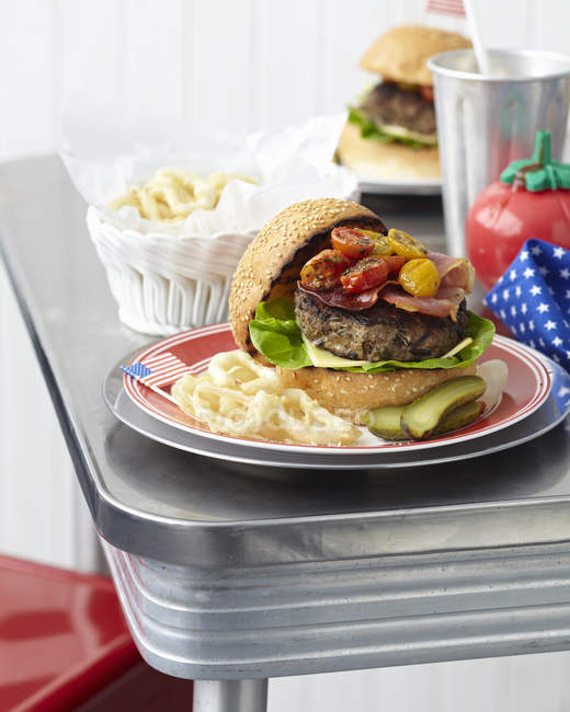 Cheeseburger e anéis de cebola servidos na placa — Fotografia de Stock