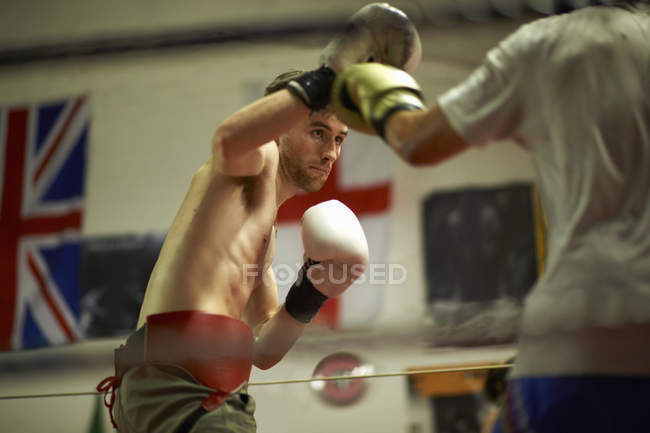Two boxers sparring in boxing ring — Stock Photo