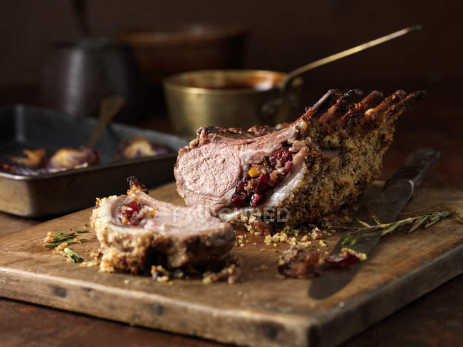 Lamb rack rare medium with cranberry and clementine stuffing and rosemary — Stock Photo