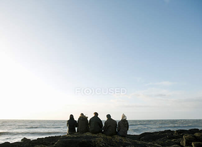 Gruppo di amici seduti sulla roccia — Foto stock