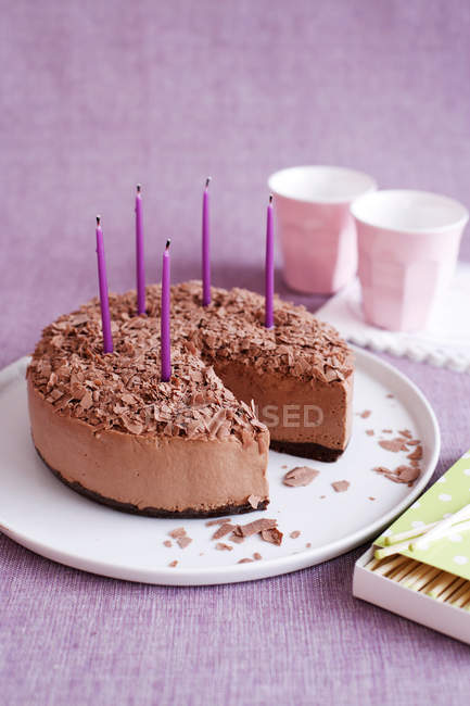 Mousse cake with birthday candles — Stock Photo