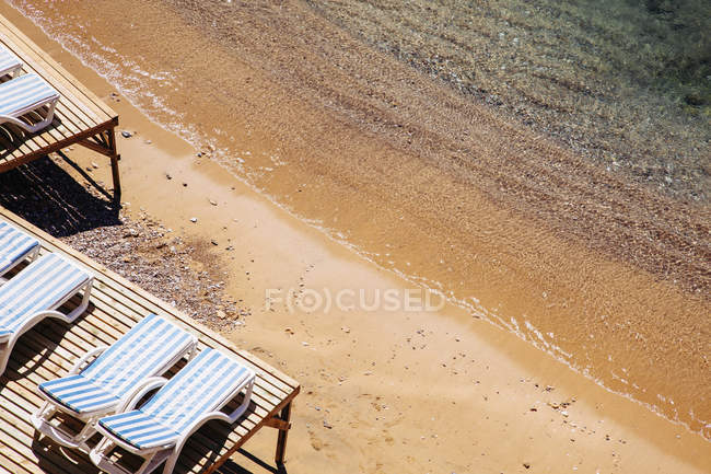 Шезлонги на піщаному пляжі, підвищений вид — стокове фото
