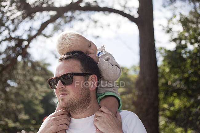 Padre che porta giovane figlio sulle spalle — Foto stock