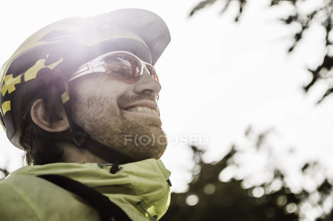 Profile of male cyclist in helmet outdoors — Stock Photo