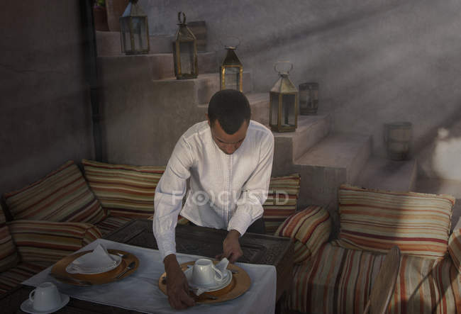 Waiter preparing place settings, Marrakesh, Morocco — Stock Photo