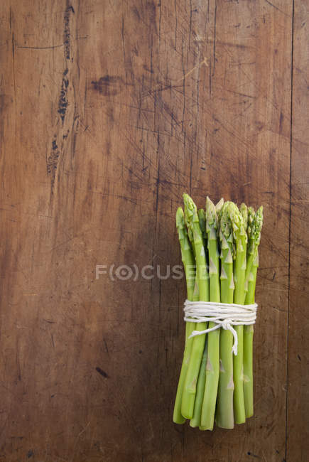 Bunch of fresh asparagus tied with string — Stock Photo