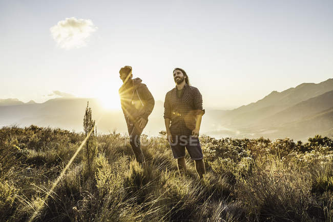 Friends standing on grassland together — Stock Photo