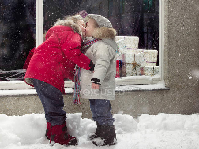 Children kissing in snow, selective focus — Stock Photo