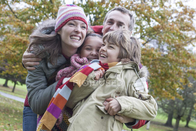 Family fooling around in park, laughing — Stock Photo