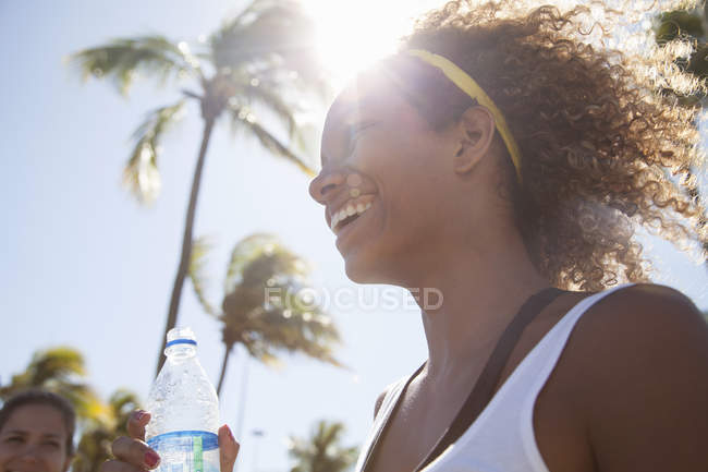 Young woman with curly hair, smiling — Stock Photo