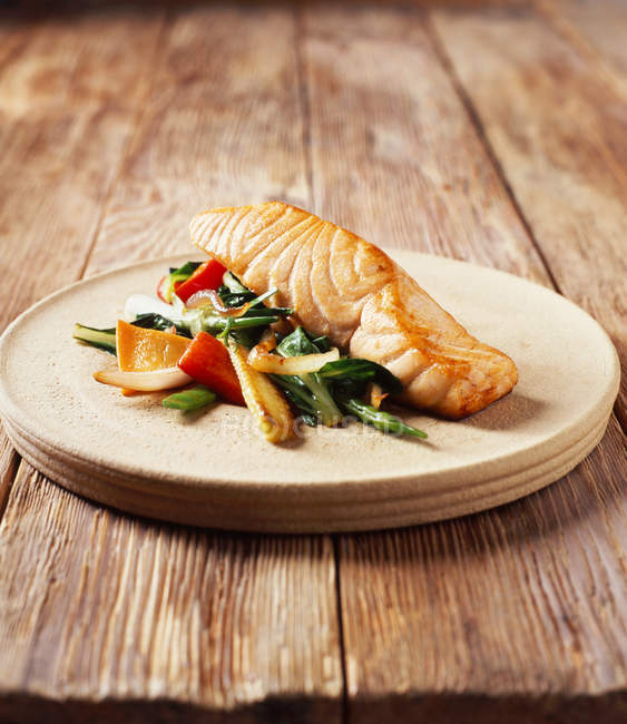 Salmon with stir fry vegetables on plate — Stock Photo