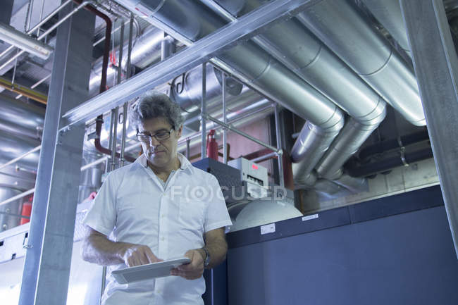 Engineer using digital tablet in power station — Stock Photo