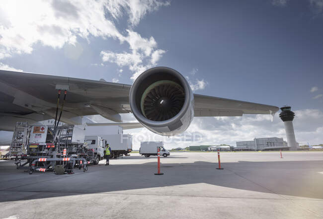View of A380 jet engine and control tower at airport — Stock Photo