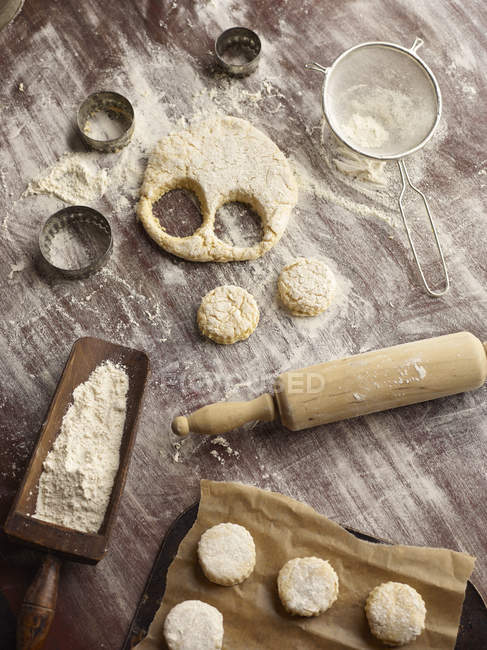 Top view of scone dough and pastry cutters — Stock Photo