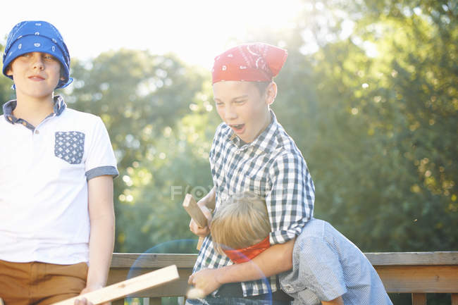 Three little boys playing together in park — Stock Photo