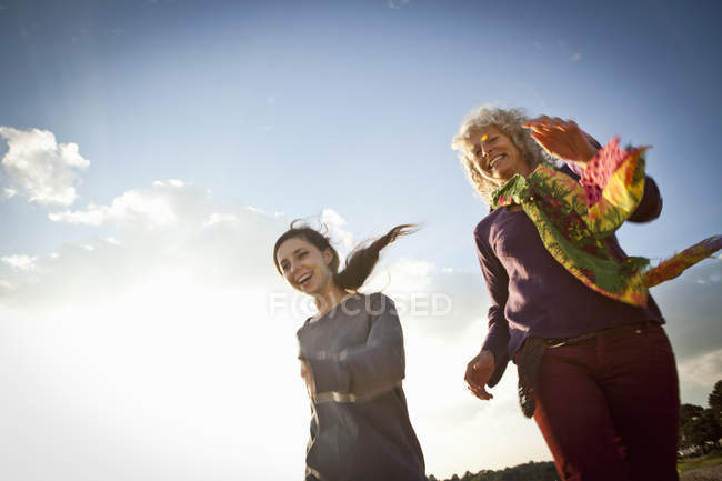 Mother and daughter enjoying beach, low angle view — Stock Photo