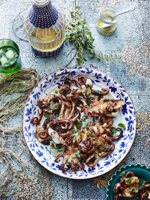 Dish chargrilled octopus served and portion on plate — Stock Photo