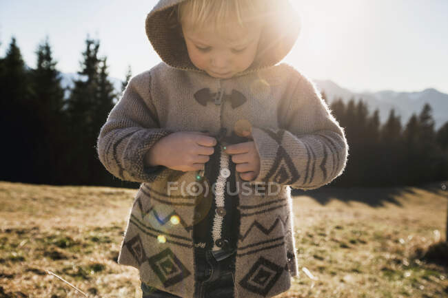 Female toddler fastening hooded jacket, Tegernsee, Bavaria, Germany — Stock Photo