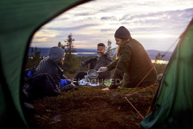 Senderistas masculinos relajándose en viajes, Laponia, Finlandia - foto de stock