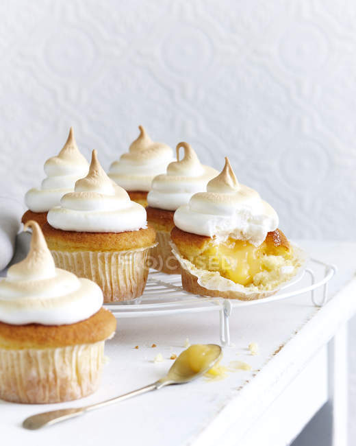 Lemon cupcakes with meringue top and fork on table — Stock Photo