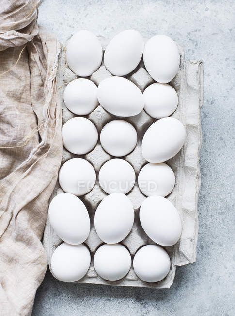 Верхний вид белых яиц в коробке — стоковое фото