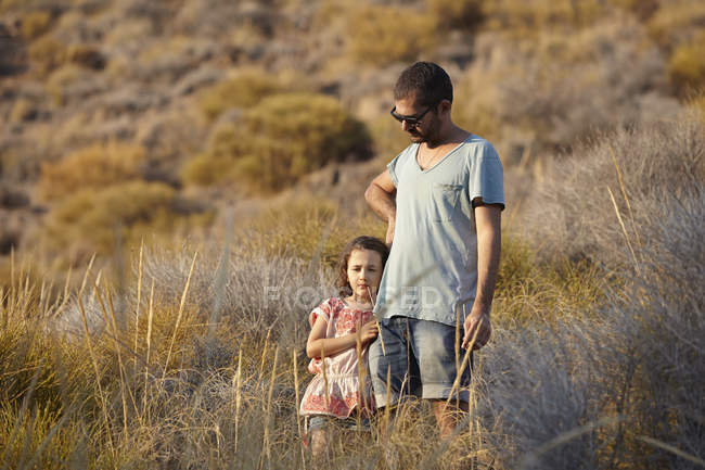 Father and daughter standing on hillside, Almeria, Andalusia, Spain — Stock Photo