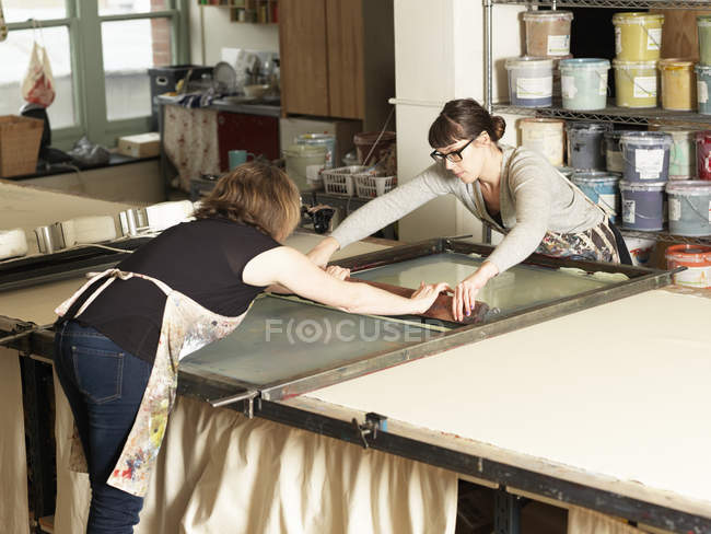 Women hand-printing textile in workshop — Stock Photo