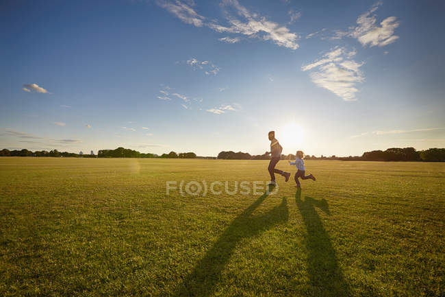 Pai e filho no parque no prado verde — Fotografia de Stock