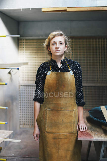 Portrait of young craftswoman in organ workshop — Stock Photo