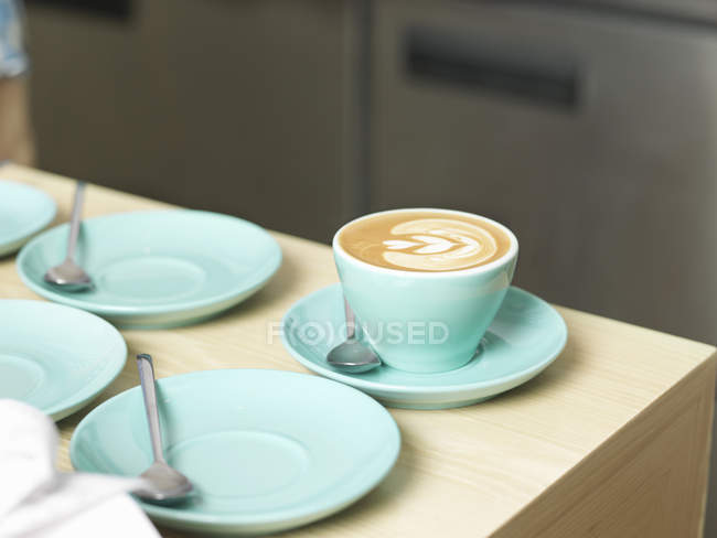 Cup of coffee and saucers on table — Stock Photo