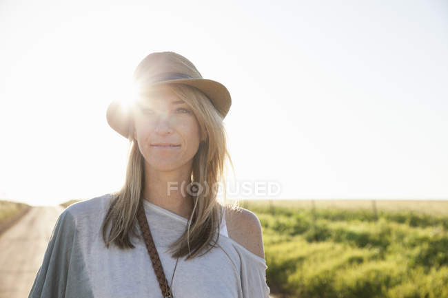 Mid adult woman on country road — Stock Photo