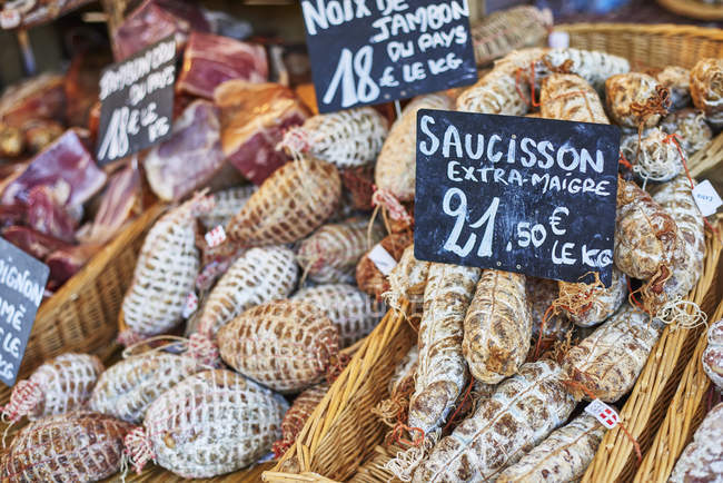 Cured sausages on French market stall, close-up — Stock Photo