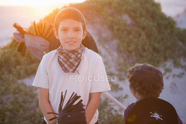 Two boys with hobby horses in sand dunes — Stock Photo