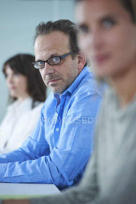 Portrait of businessman in row of female colleagues — Stock Photo