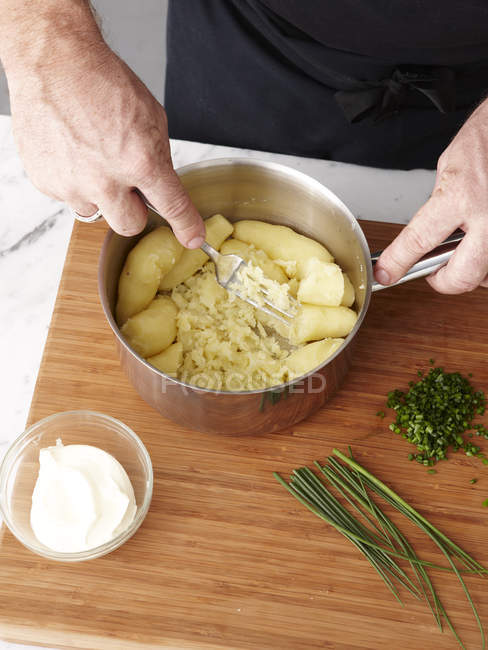 Cropped image of chief making rolled rare lamb ratatouille — Stock Photo