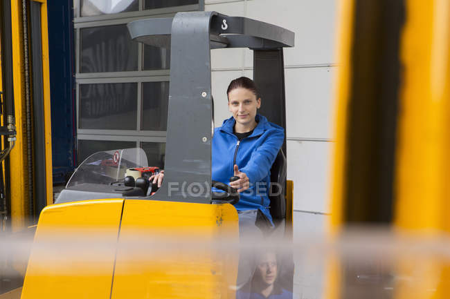 Factory worker operating forklift — Stock Photo