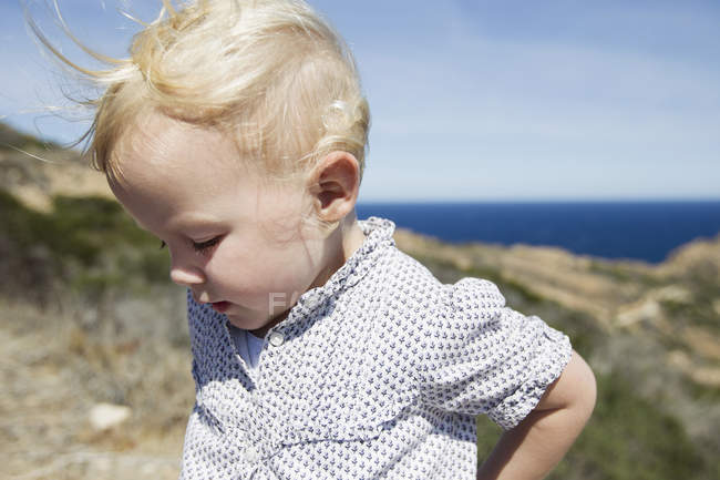 Female toddler looking down at coast, Calvi, Corsica, France — Stock Photo