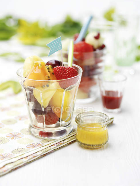 Frutas misturadas em vidro com molho na mesa — Fotografia de Stock