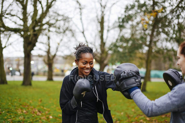 Young adult female boxers training together in park — Stock Photo