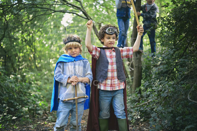 Two boys dressed up and playing in forest — Stock Photo